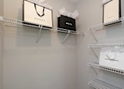 Thumbnail 25 of 49 - Three bags with Gucci, Chanel, and Dolce & Gabbana logos are displayed on shelves.