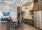 Thumbnail 5 of 45 - A modern kitchen with a wooden table and chairs.