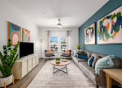 Thumbnail 23 of 45 - A living room with a television, couch, and two paintings on the wall.