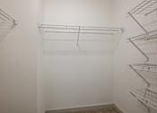 Thumbnail 26 of 45 - Empty shelves in a white pantry.