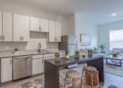 Thumbnail 2 of 18 - a kitchen with white cabinets and stainless steel appliances