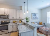 Thumbnail 6 of 10 - a kitchen with granite counter tops and stainless steel appliances