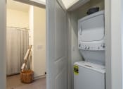 Thumbnail 10 of 10 - a small laundry room with a washer and dryer