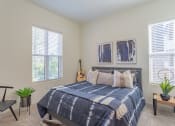 Thumbnail 7 of 10 - a bedroom with a bed and two windows