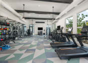 Thumbnail 11 of 37 - a workout room with treadmills and other exercise equipment