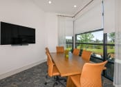 Thumbnail 8 of 37 - a conference room with a table and chairs and a tv on the wall