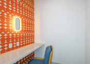 Thumbnail 10 of 37 - a chair in front of a orange wall with a small window