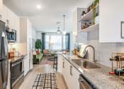 Thumbnail 17 of 37 - a kitchen with white cabinets and stainless steel appliances