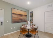 Thumbnail 18 of 37 - a dining room with a table and chairs and a large painting on the wall