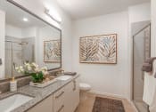 Thumbnail 23 of 37 - a bathroom with a large mirror and two sinks