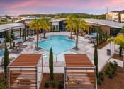 Thumbnail 28 of 37 - an aerial view of a resort style pool with palm trees and umbrellas