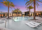 Thumbnail 1 of 37 - a large swimming pool with palm trees in front of a building