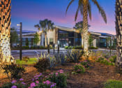 Thumbnail 3 of 37 - a building with palm trees in front of it