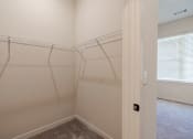 Thumbnail 12 of 19 - the spacious closet in the bedroom of a home with a large window