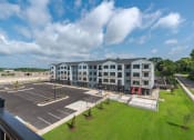 Thumbnail 17 of 19 - an aerial view of an empty parking lot and an apartment building