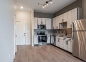 Thumbnail 2 of 19 - a kitchen with white cabinets and stainless steel appliances