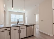 Thumbnail 5 of 19 - a kitchen with a sink and a counter top