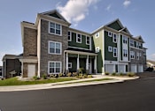 Thumbnail 26 of 26 - Apartment building with a parking lot in front.