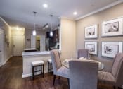 Thumbnail 7 of 30 - a dining room and kitchen with a table and chairs
