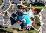Thumbnail 20 of 30 - an aerial view of a swimming pool in a neighborhood with houses