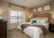 Thumbnail 8 of 30 - a bedroom with a large bed and a window