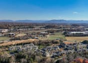 Thumbnail 29 of 30 - an aerial view of a city with mountains in the background
