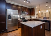 Thumbnail 5 of 30 - a kitchen with stainless steel appliances and granite counter tops