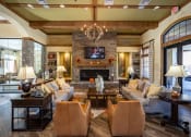 Thumbnail 14 of 30 - a living room with couches and chairs and a fireplace