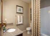 Thumbnail 9 of 30 - a bathroom with a sink and a toilet and a shower