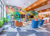 Thumbnail 12 of 20 - a lobby with a colorful mural on the wall and a checkered floor