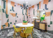 Thumbnail 9 of 20 - a dining room with a white table and yellow chairs