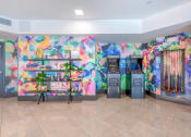 Thumbnail 10 of 20 - a colorful lobby with two atm machines and a bookshelf