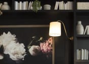 Thumbnail 8 of 44 - a living room with a sofa and a table with a vase of flowers on it
