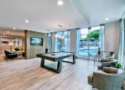 Thumbnail 22 of 31 - Memphis, TN Luxury Apartments For Rent - The Citizen - Clubhouse Lounge With Wifi, Billards, TV, Plenty Of Seating Areas, View Of The Pool, And A Table