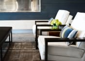 Thumbnail 19 of 31 - a living room with a white couch and a table