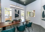 Thumbnail 15 of 38 - a dining room with a long wooden table and green chairs
