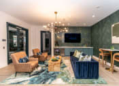 Thumbnail 12 of 38 - a living room with a blue couch and a tv
