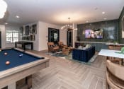 Thumbnail 16 of 38 - a game room with a pool table and a tv