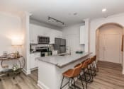 Thumbnail 2 of 38 - a kitchen with a marble counter top and a sink