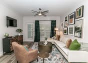 Thumbnail 5 of 38 - a living room with a couch and a ceiling fan