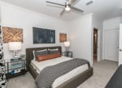 Thumbnail 9 of 38 - a bedroom with a bed and a ceiling fan