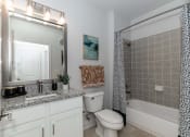 Thumbnail 8 of 38 - a bathroom with a sink and a toilet and a shower