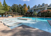 Thumbnail 27 of 38 - a large swimming pool with a house in the background