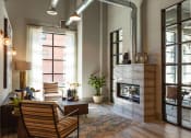 Thumbnail 31 of 47 - a living room with a fireplace and a large window