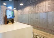 Thumbnail 40 of 47 - a locker room with lockers and a table with a tv