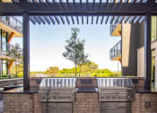 Thumbnail 44 of 47 - Downtown Memphis, TN Luxury Apartments - The Landing - Grilling Station under Pergola.