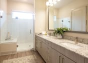 Thumbnail 9 of 47 - a bathroom with two sinks and a shower and a mirror