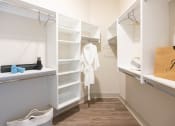 Thumbnail 7 of 47 - Luxury Apartments in Downtown Memphis, TN - The Landing - Spacious Closet with Hardwood Flooring, Shelves, and Hanging Racks.