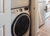 Thumbnail 27 of 47 - a front loading washer and dryer in a small closet