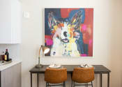 Thumbnail 25 of 47 - a dining room with two chairs and a painting on the wall
